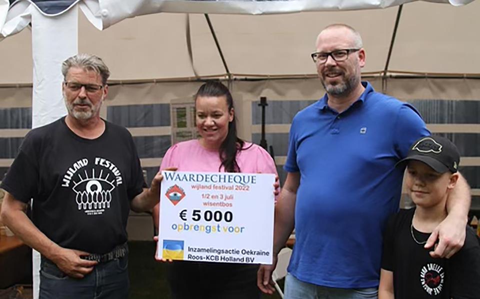 John Hagel van het WijLand Festival overhandigd de cheque aan familie Baars van Roos KCB.
